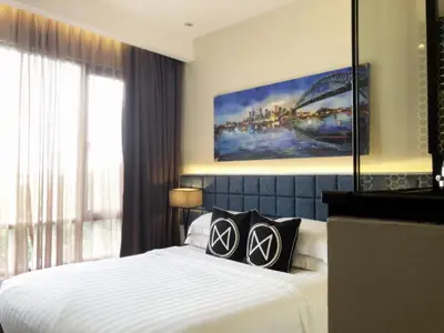a bedroom with a bed with two pillows on it at M Roof Hotel & Residences in Ipoh