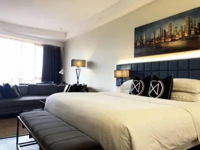 a bedroom with a large bed and a couch at M Roof Hotel & Residences in Ipoh