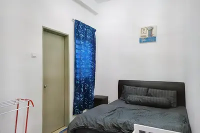 a bedroom with a bed and a blue curtain at Tropical Dream CH night market in Cameron Highlands