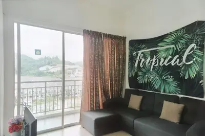 a living room with a couch and a large window at Tropical Dream CH night market in Cameron Highlands