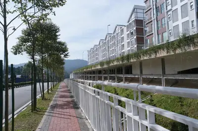 an empty street next to a tall building at Tropical Dream CH night market in Cameron Highlands
