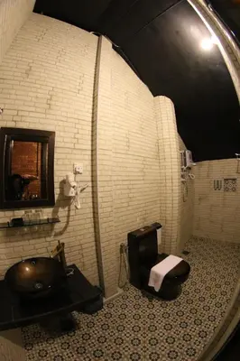 a bathroom with a tub and a sink and a mirror at JQ Ban Loong Boutique Hotel in Ipoh