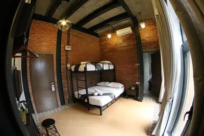 a room with two bunk beds in a brick wall at JQ Ban Loong Boutique Hotel in Ipoh