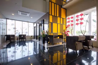 a lobby with chairs and tables in a building at OMG Hotel in Simpang Ampat