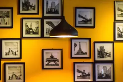 a wall with pictures offamousfamous buildings and monuments at OMG Hotel in Simpang Ampat
