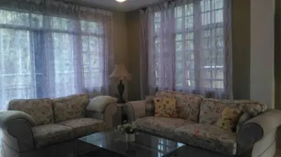 a living room with two couches and a table at SA Apartments @ Crown Imperial Court in Cameron Highlands