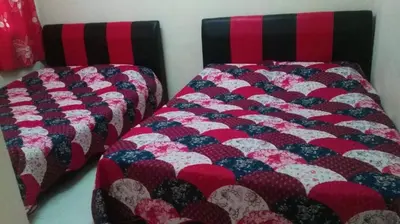 two beds sitting next to each other in a room at SA Apartments @ Crown Imperial Court in Cameron Highlands