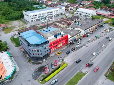 an aerial view of a city with a red building at Lux Hotel in Teluk Intan