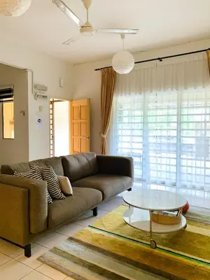a living room with a couch and a glass table at D'Houzz in Sungai Petani