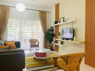 a living room with a couch and a tv at D'Houzz in Sungai Petani