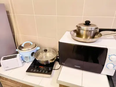 a microwave oven with a pot on top of it at MY SWEETHUB HOMESTAY @ CAMERON HIGHLANDS in Cameron Highlands