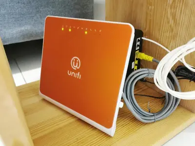 a laptop sitting on a table with a bunch of cords at MY SWEETHUB HOMESTAY @ CAMERON HIGHLANDS in Cameron Highlands