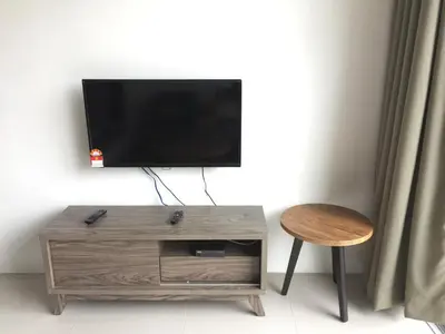 a flat screen tv sitting on top of a wooden table at Cameron Barrington Square 1Room @ Golden Hill in Cameron Highlands