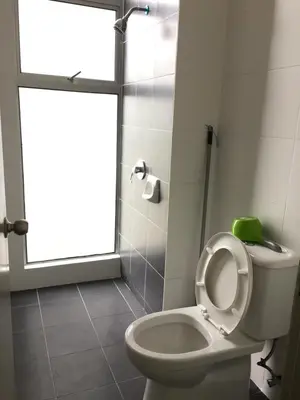 a bathroom with a toilet with the seat up and a window at Cameron Barrington Square 1Room @ Golden Hill in Cameron Highlands