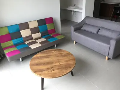 a living room with a couch and a table at Cameron Barrington Square 1Room @ Golden Hill in Cameron Highlands