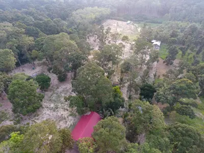 an overhead view of a pink house in the forest at Chalet Kampong Semawar in Kuala Kangsar