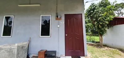 a front door of a house with a red door at Chalet Kampong Semawar in Kuala Kangsar