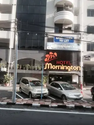 two cars parked in front of a hotel morrison at Lumut Waterfront Apartment 62 in Lumut