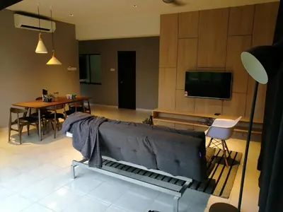 a living room with a couch and a tv at Lumut Waterfront Apartment 62 in Lumut