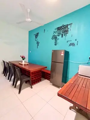 a dining room with a table and a refrigerator at Ipoh Meru Animation Homestay by Grab A Stay in Ipoh
