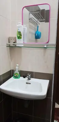 a bathroom with a white sink and a mirror at Fahaz Kamunting Taiping in Taiping