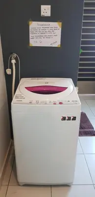 a white washing machine with a red plate on top at Fahaz Kamunting Taiping in Taiping