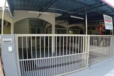 a white gate in front of a building at Taiping Cozy Homestay in Taiping