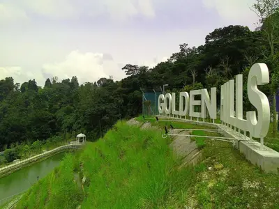 a large sign that reads columbias on the side of a river at Golden Hill 1 Room Apt at Night Market in Cameron Highlands