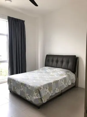 a bed sitting in a room with azeb at Golden Hill 1 Room Apt at Night Market in Cameron Highlands