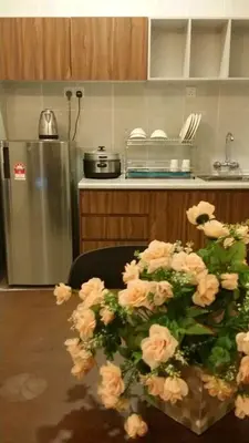 a kitchen with a table with a bunch of flowers at Golden Hill 1 Room Apt at Night Market in Cameron Highlands