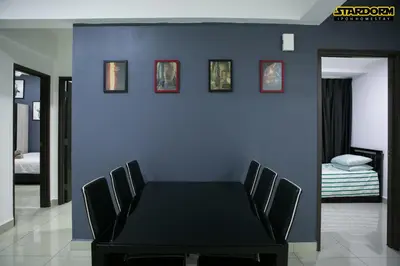 a dining room with a black table and chairs at Ipoh City Center Stardorm Ipoh Homestay in Ipoh