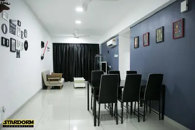 a dining room with a table and black chairs at Ipoh City Center Stardorm Ipoh Homestay in Ipoh