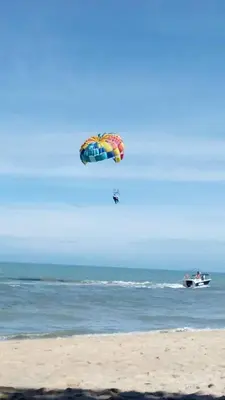 a person is flying a kite on the beach at 5-MINS WALK TO BEACH WITH POOL, Batu Ferringhi in Batu Ferringhi