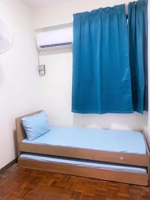 a bed in a room with a blue curtain at 5-MINS WALK TO BEACH WITH POOL, Batu Ferringhi in Batu Ferringhi