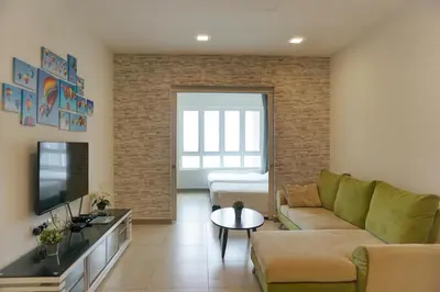 a living room with a couch and a tv at PM Octagon Ipoh Suites & Apartment 1 in Ipoh