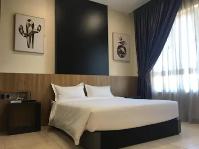a bedroom with a large bed and a window at PM Octagon Ipoh Suites & Apartment 1 in Ipoh