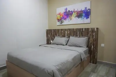 a bed with a wooden headboard in a bedroom at PM Octagon Ipoh Suites & Apartment 1 in Ipoh