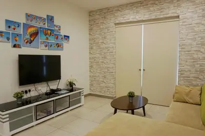 a living room with a couch and a television at PM Octagon Ipoh Suites & Apartment 1 in Ipoh