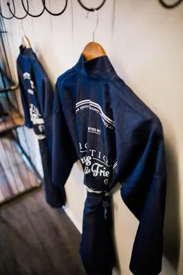 a group of blue jackets hanging on a wall at M Boutique Kampar in Kampar