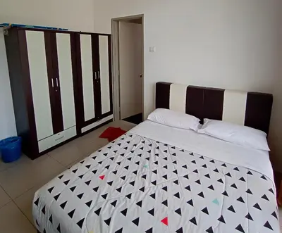 a bedroom with a large bed with a black and white comforter at Cameron 2Room Square @Golden Hill in Cameron Highlands