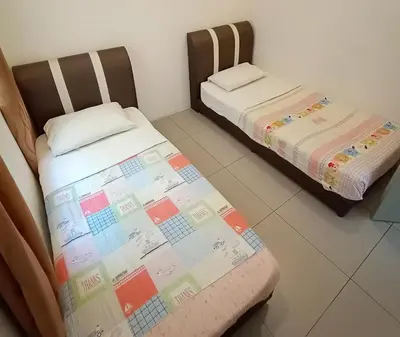 two beds sitting next to each other in a room at Cameron 2Room Square @Golden Hill in Cameron Highlands