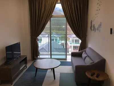 a living room with a couch and a tv and a table at Cameron 2Room Square @Golden Hill in Cameron Highlands