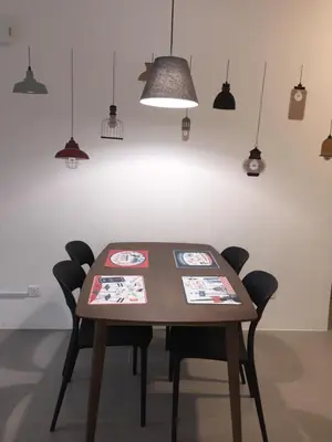 a dining room table with chairs and pendant lights at Cameron 2Room Square @Golden Hill in Cameron Highlands