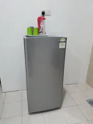 a small refrigerator with a drink on top of it at Walking Distance To The Beach, Pangkor in Pangkor