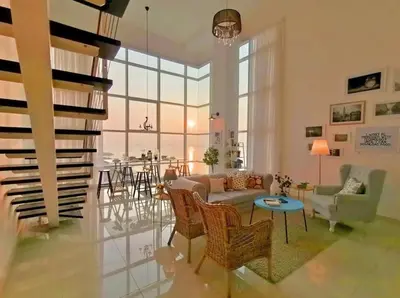 a living room with a couch and chairs and a table at Maritime Suites Holiday Rental in George Town