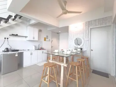 a kitchen with a counter and stools in it at Maritime Suites Holiday Rental in George Town