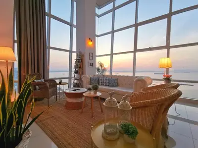 a living room with a couch and a large window at Maritime Suites Holiday Rental in George Town