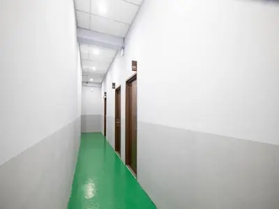 a corridor with a green floor in a hospital hallway at JQ BL Hotel, Ipoh in Ipoh