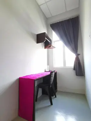 a room with a pink table and chairs in a room at JQ BL Hotel, Ipoh in Ipoh