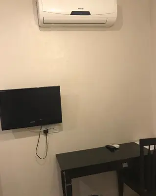 a living room with a tv and a table and a table sidx sidx at Se One Hotel in Butterworth